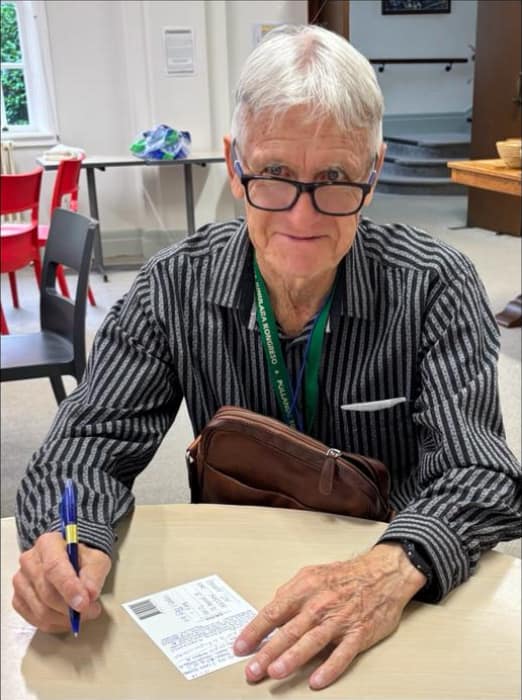 Man with pen at table